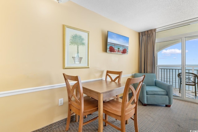 2000 Ocean Blvd N Unit Ph12, Myrtle Beach, SC 29577 - dining area featuring a textured ceiling, a water view, and carpet floors