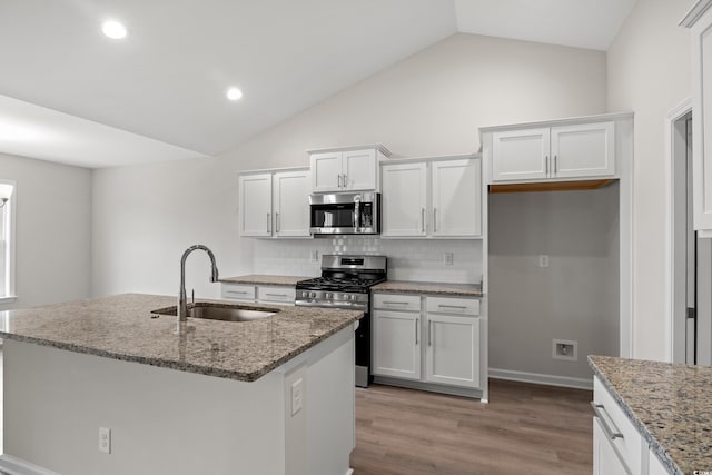192 Six Mile Creek Dr, Georgetown, SC 29440 - kitchen featuring stainless steel appliances, a sink, decorative backsplash, white cabinets, and lofted ceiling