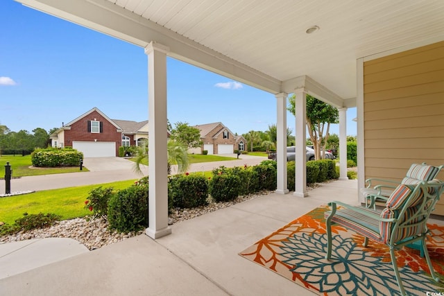 1035 Brentford Pl, Myrtle Beach, SC 29579 - view of patio with a garage, covered porch, and a residential view