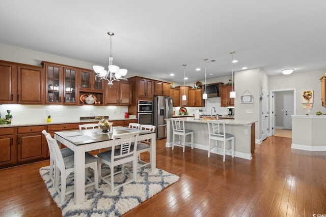 1035 Brentford Pl, Myrtle Beach, SC 29579 - dining space with a chandelier, recessed lighting, dark wood finished floors, and baseboards