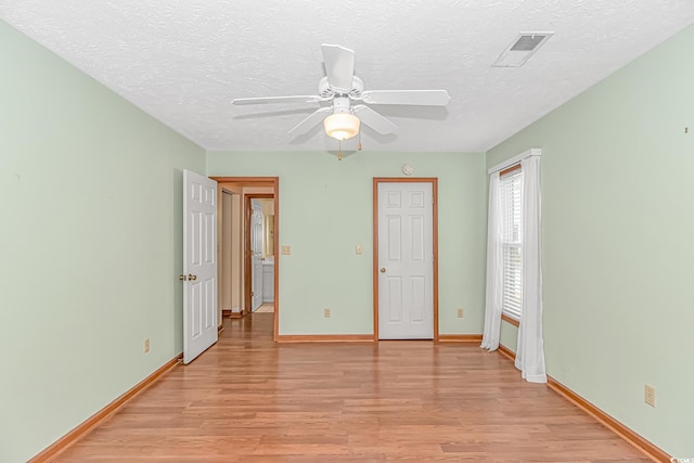 934 Tiffany Ln, North Myrtle Beach, SC 29582 - unfurnished bedroom with light wood-style floors, a textured ceiling, baseboards, and a ceiling fan