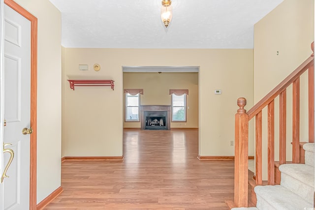 934 Tiffany Ln, North Myrtle Beach, SC 29582 - hallway with stairway, light wood finished floors, and baseboards