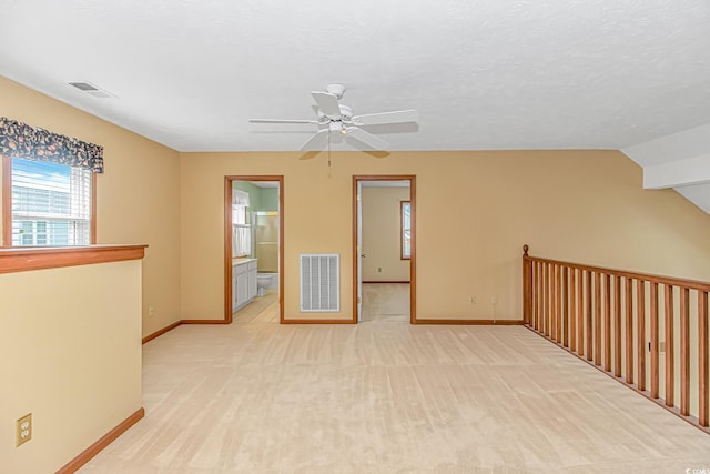 934 Tiffany Ln, North Myrtle Beach, SC 29582 - spare room with baseboards, a ceiling fan, light carpet, and vaulted ceiling