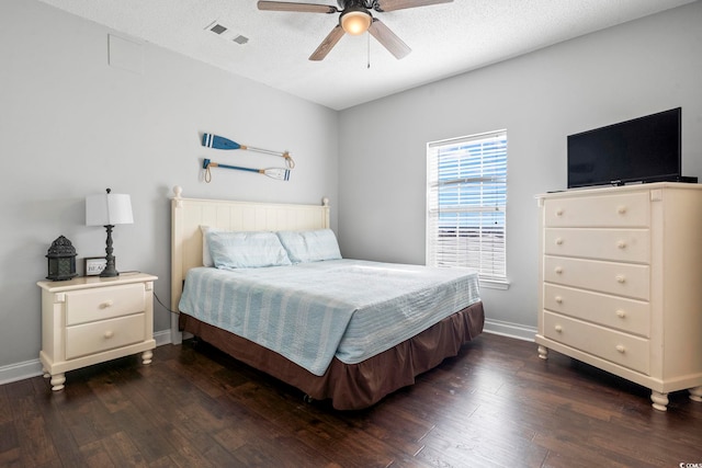 bedroom with dark wood-type flooring, baseboards, and a ceiling fan