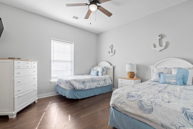 bedroom featuring wood finished floors, ceiling fan, a textured ceiling, and baseboards