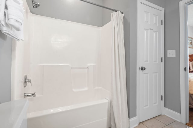 bathroom with tile patterned flooring, shower / bath combo, and baseboards