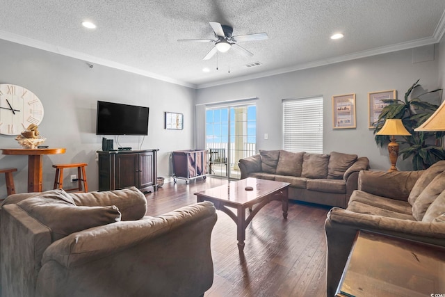 living area with ceiling fan, a textured ceiling, dark wood-type flooring, ornamental molding, and recessed lighting