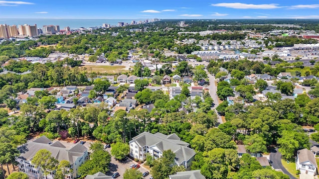 601 Hillside Dr Unit 4424, North Myrtle Beach, SC 29582 - aerial overview of property's location featuring nearby urban area, a tree filled landscape, and a large body of water