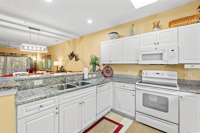 601 Hillside Dr Unit 4424, North Myrtle Beach, SC 29582 - kitchen featuring white appliances, a sink, white cabinetry, a peninsula, and decorative light fixtures