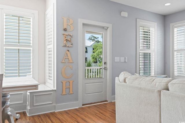 entryway featuring wood finished floors, baseboards, and recessed lighting