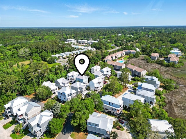 aerial perspective of suburban area with a forest