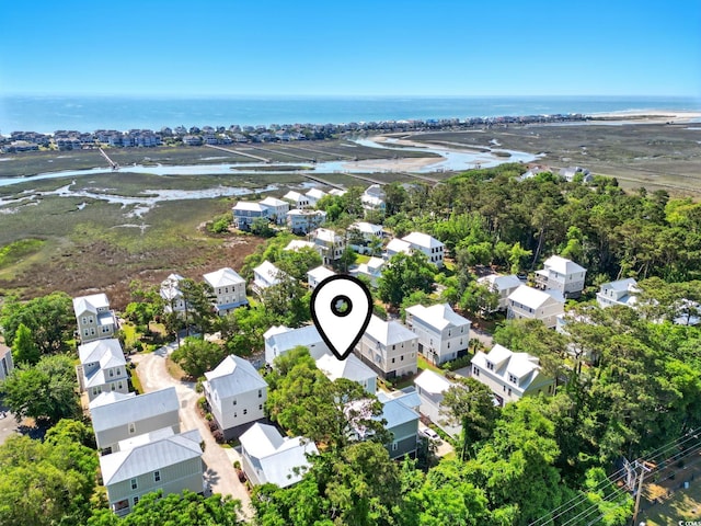 aerial view of residential area featuring a nearby body of water
