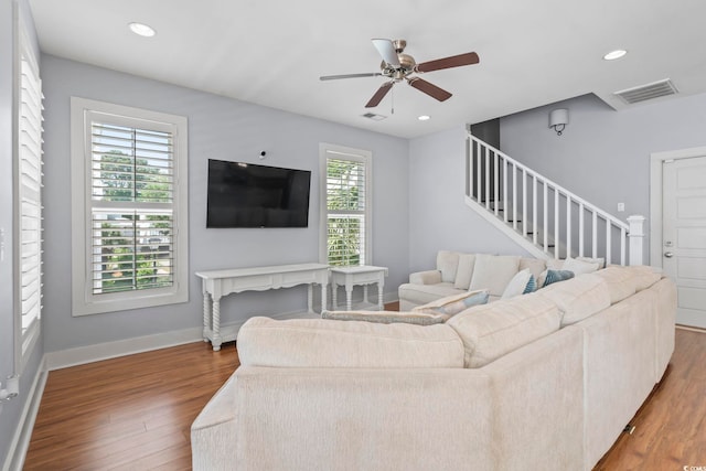 living room featuring stairway, wood finished floors, ceiling fan, baseboards, and recessed lighting