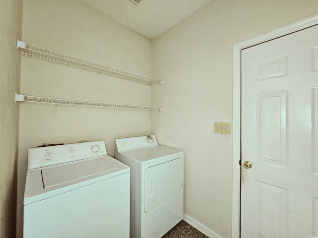 laundry room featuring washer and dryer and baseboards