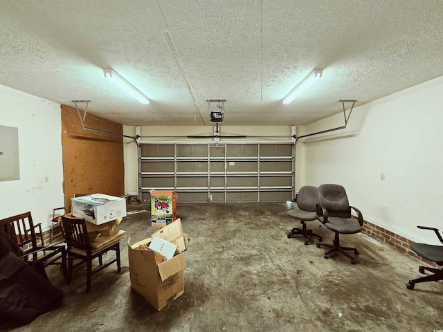 garage with a garage door opener and electric panel