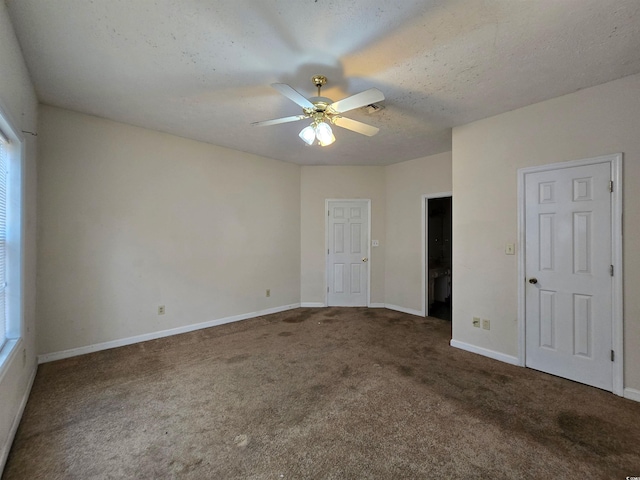 unfurnished bedroom featuring carpet, baseboards, a ceiling fan, and a textured ceiling