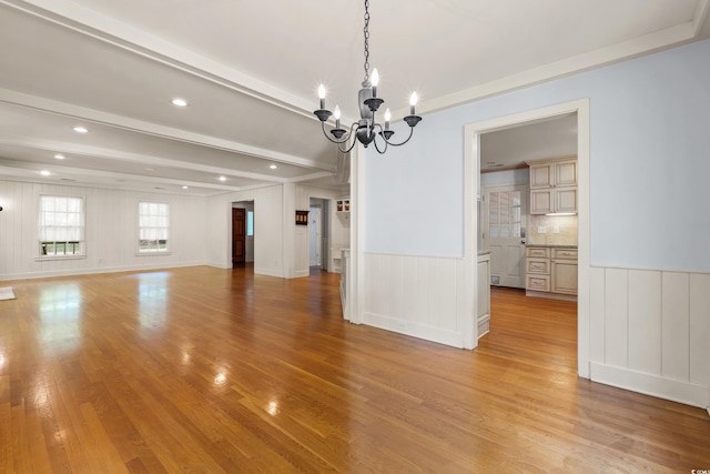 54 River Birch Ln, Pawleys Island, SC 29585 - unfurnished dining area with a chandelier, light wood-type flooring, a wainscoted wall, recessed lighting, and a decorative wall
