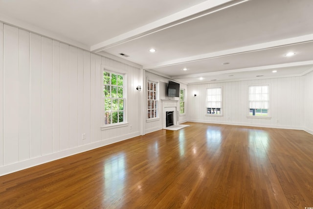 54 River Birch Ln, Pawleys Island, SC 29585 - unfurnished living room featuring beam ceiling, wood finished floors, a fireplace, healthy amount of natural light, and baseboards