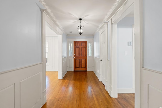 54 River Birch Ln, Pawleys Island, SC 29585 - hall featuring light wood-style floors, crown molding, and a decorative wall