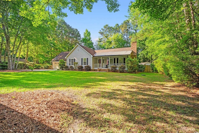 54 River Birch Ln, Pawleys Island, SC 29585 - ranch-style home with covered porch, a chimney, an attached garage, and a front yard
