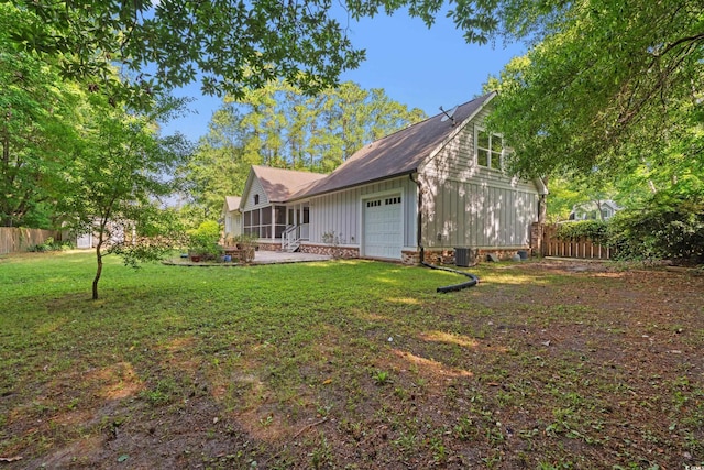 54 River Birch Ln, Pawleys Island, SC 29585 - rear view of property with board and batten siding, central AC, and a garage