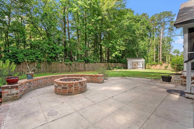 54 River Birch Ln, Pawleys Island, SC 29585 - view of patio / terrace featuring a fire pit, a storage unit, and an outbuilding