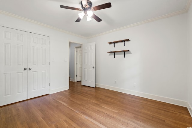 54 River Birch Ln, Pawleys Island, SC 29585 - unfurnished bedroom with light wood finished floors, baseboards, ornamental molding, a closet, and a ceiling fan