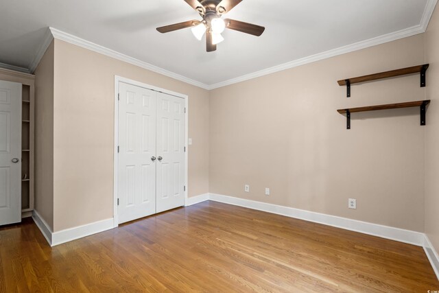 54 River Birch Ln, Pawleys Island, SC 29585 - unfurnished bedroom with ornamental molding, wood finished floors, baseboards, a ceiling fan, and a closet