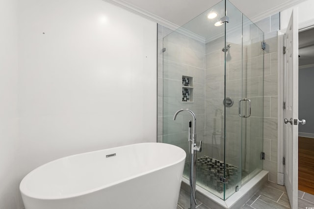 54 River Birch Ln, Pawleys Island, SC 29585 - bathroom with ornamental molding, a stall shower, a soaking tub, and baseboards