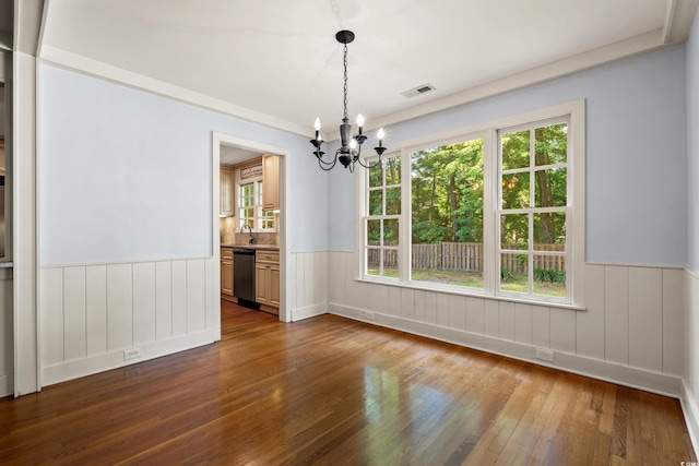 54 River Birch Ln, Pawleys Island, SC 29585 - unfurnished dining area featuring a chandelier, dark wood-style flooring, a wainscoted wall, and a sink