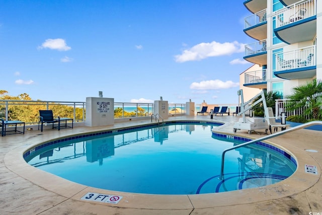 community pool with a patio area