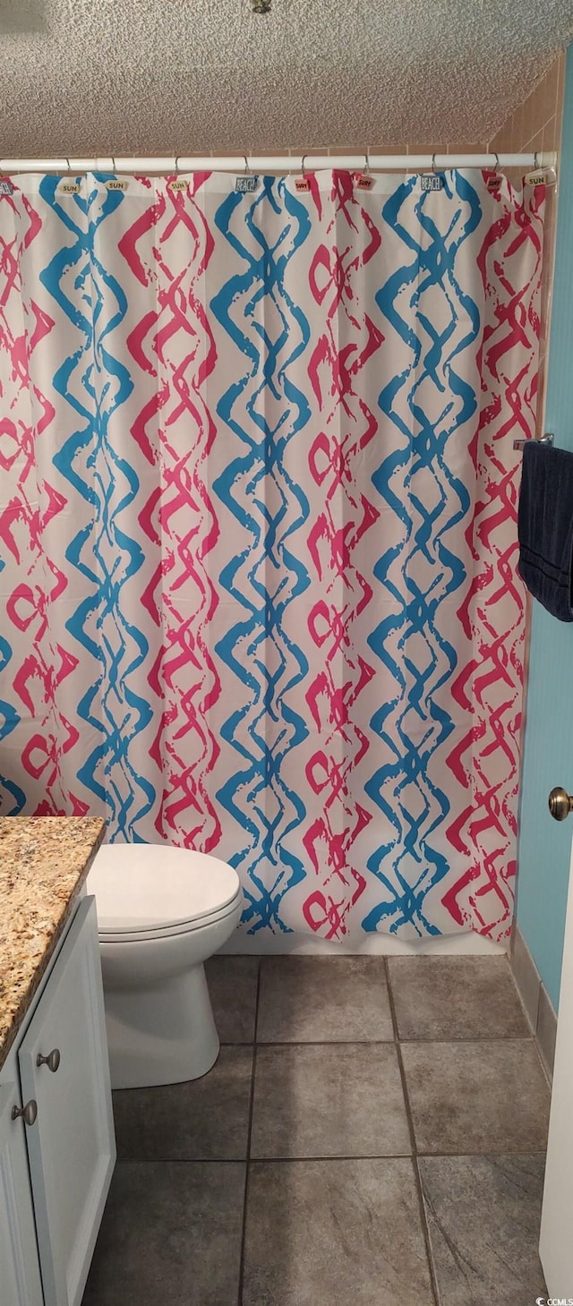 bathroom featuring vanity, a textured ceiling, toilet, and a shower with curtain