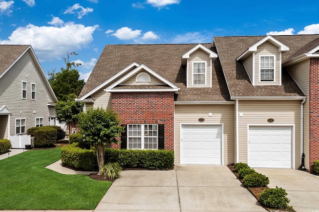 4355 Willoughby Ln Unit 401, Myrtle Beach, SC 29577 - view of front facade featuring roof with shingles, driveway, a front yard, and an attached garage