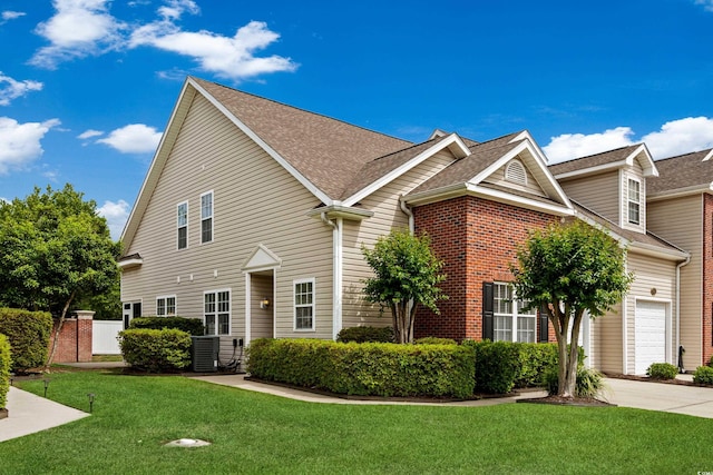 4355 Willoughby Ln Unit 401, Myrtle Beach, SC 29577 - traditional home with a front yard, a garage, a shingled roof, and concrete driveway