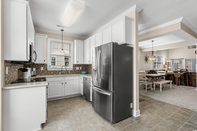4355 Willoughby Ln Unit 401, Myrtle Beach, SC 29577 - kitchen featuring stainless steel appliances, a sink, open floor plan, white cabinetry, and crown molding