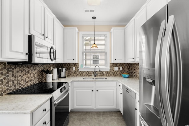 4355 Willoughby Ln Unit 401, Myrtle Beach, SC 29577 - kitchen with appliances with stainless steel finishes, a sink, white cabinets, light tile patterned floors, and crown molding