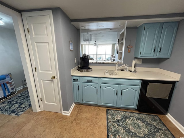 9500 Shore Dr Unit 17B, Myrtle Beach, SC 29572 - kitchen with dishwashing machine, blue cabinets, and light countertops