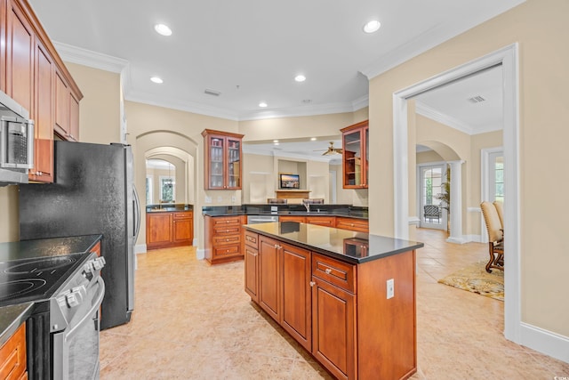 8546 San Marcello Dr Unit 1-102, Myrtle Beach, SC 29579 - kitchen featuring arched walkways, ornate columns, appliances with stainless steel finishes, crown molding, and dark countertops