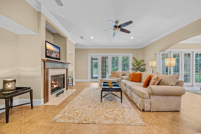 8546 San Marcello Dr Unit 1-102, Myrtle Beach, SC 29579 - tiled living area with ornamental molding, a ceiling fan, arched walkways, plenty of natural light, and a high end fireplace