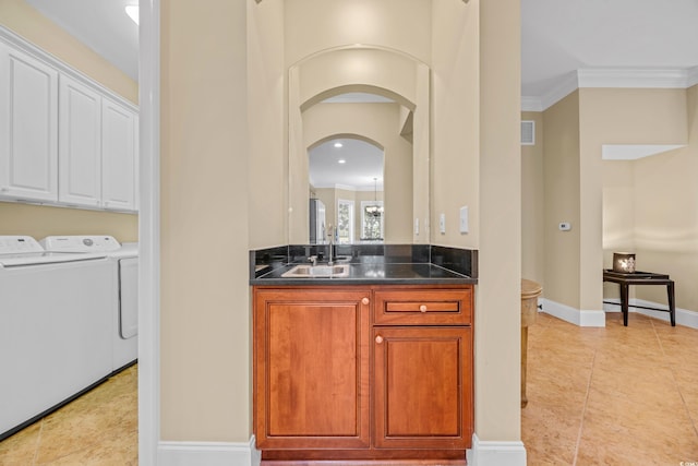 8546 San Marcello Dr Unit 1-102, Myrtle Beach, SC 29579 - bar area featuring washer and clothes dryer, a sink, light tile patterned flooring, crown molding, and baseboards