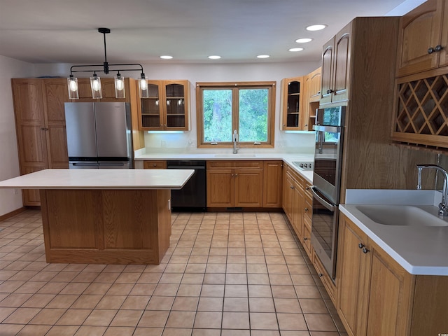 kitchen with appliances with stainless steel finishes, a sink, light tile patterned flooring, glass insert cabinets, and recessed lighting