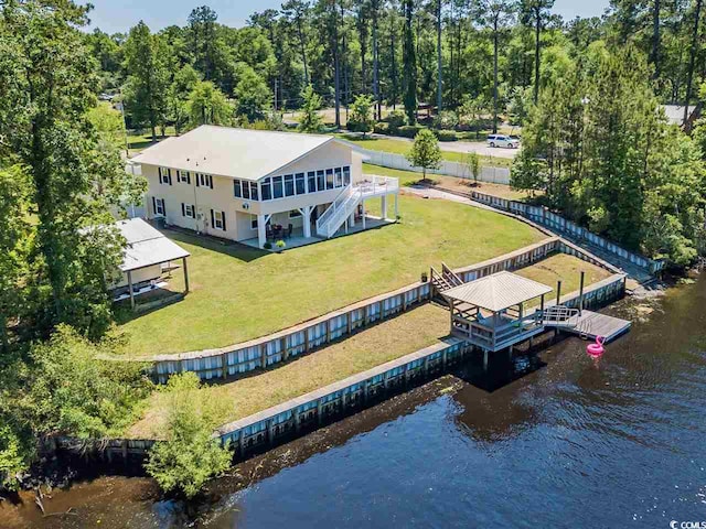 aerial view of property and surrounding area with a nearby body of water