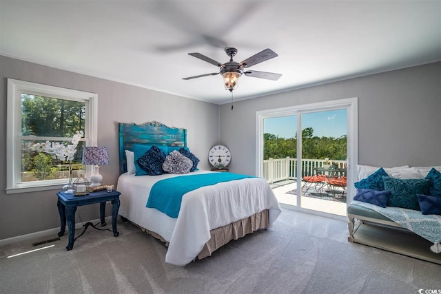 bedroom featuring access to outside, multiple windows, carpet, and crown molding
