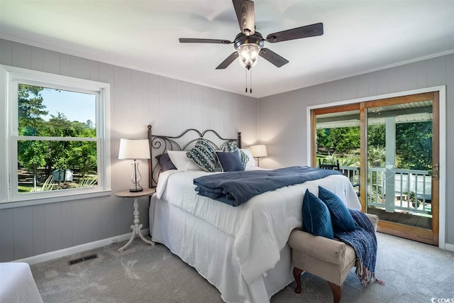 carpeted bedroom featuring access to outside, baseboards, ornamental molding, and a ceiling fan