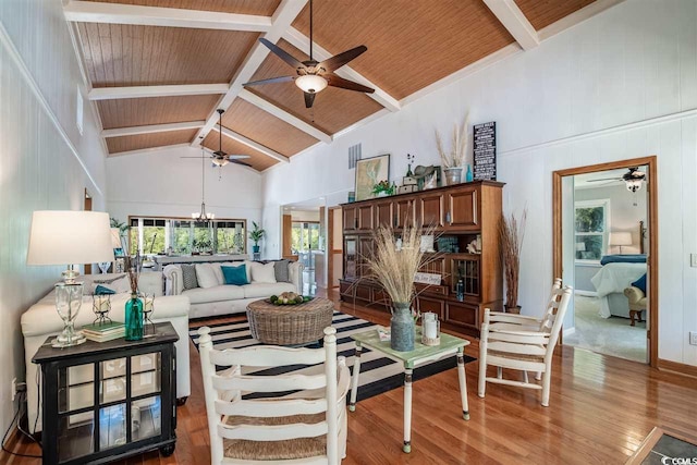 living room featuring ceiling fan, wooden ceiling, wood finished floors, high vaulted ceiling, and beamed ceiling