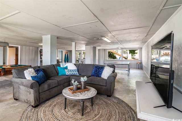 living area with finished concrete floors and billiards table
