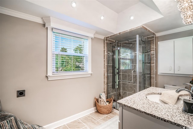 bathroom with baseboards, ornamental molding, a stall shower, vanity, and tile patterned floors
