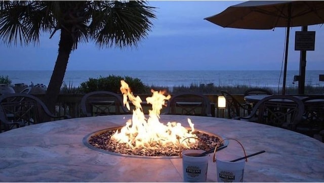 3000 Ocean Blvd N Unit 508, Myrtle Beach, SC 29577 - view of patio / terrace with an outdoor fire pit and a water view