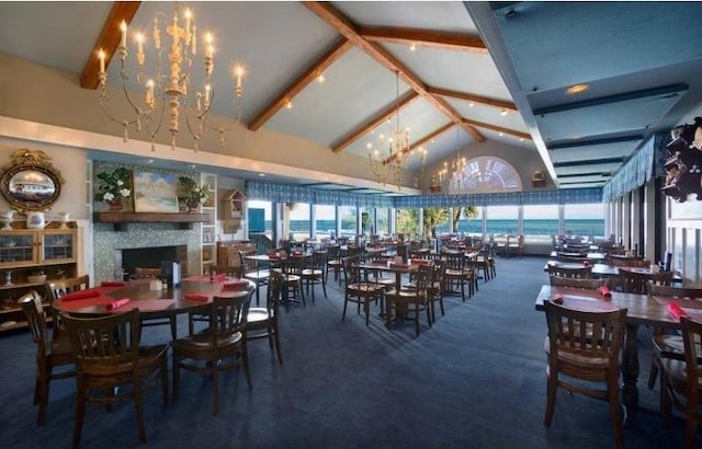 3000 Ocean Blvd N Unit 508, Myrtle Beach, SC 29577 - carpeted dining space featuring a chandelier, high vaulted ceiling, a fireplace, and beam ceiling