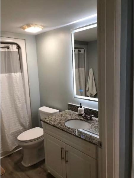 3000 Ocean Blvd N Unit 508, Myrtle Beach, SC 29577 - full bath with wood finished floors, toilet, vanity, and curtained shower